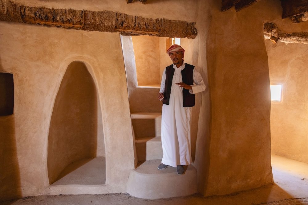 A Siwan host inside a traditional mudbrick house